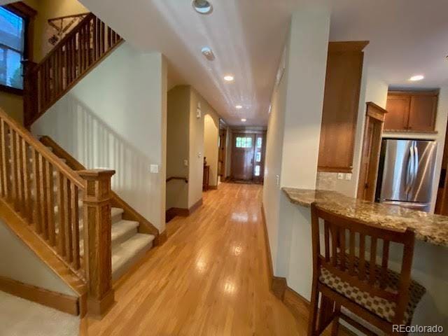 1145 S Williams St, Denver, CO 80210 - hall featuring light wood-style floors, stairs, and recessed lighting