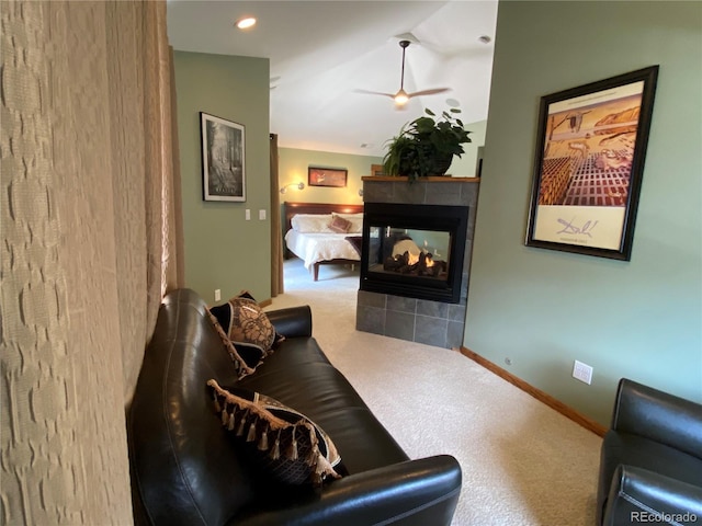 1145 S Williams St, Denver, CO 80210 - living room featuring a tiled fireplace, a ceiling fan, lofted ceiling, and carpet