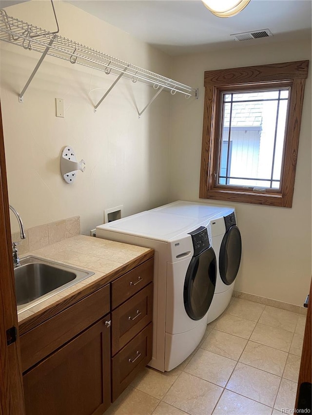 1145 S Williams St, Denver, CO 80210 - washroom featuring washer and clothes dryer, cabinet space, and light tile patterned floors