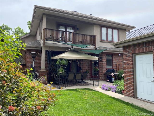 1145 S Williams St, Denver, CO 80210 - back of house with a balcony, brick siding, a patio area, a yard, and stucco siding