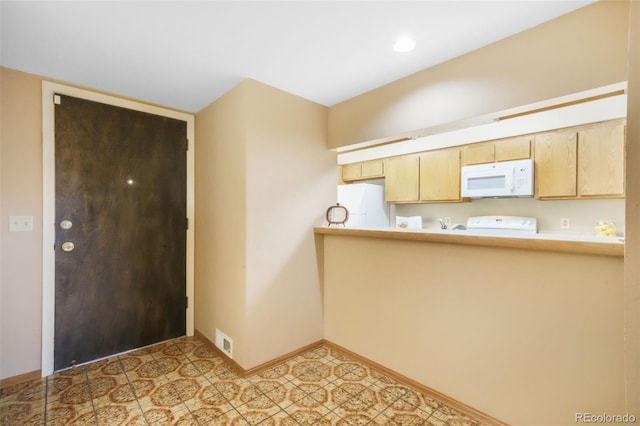 3330 Templeton Gap Rd Unit 15, Colorado Springs, CO 80907 - kitchen with white appliances, light brown cabinets, baseboards, and light countertops