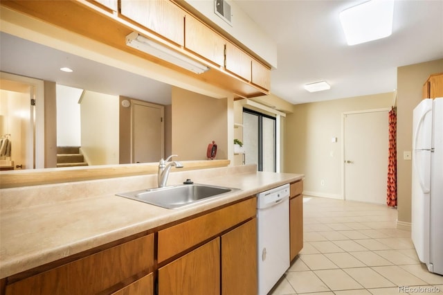 3330 Templeton Gap Rd Unit 15, Colorado Springs, CO 80907 - kitchen featuring white appliances, a sink, light countertops, light tile patterned floors, and baseboards