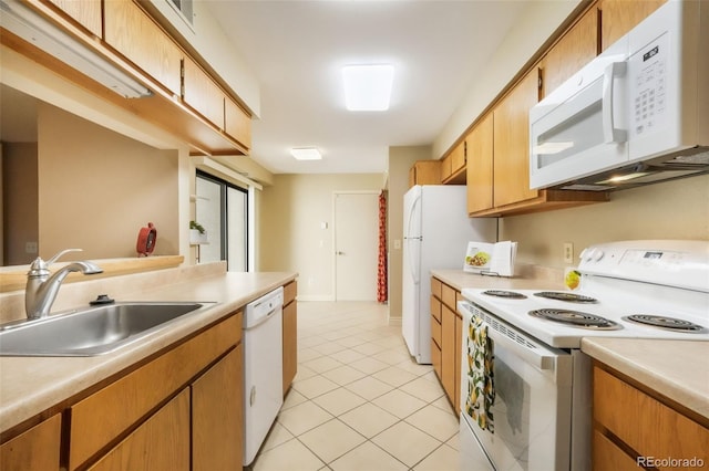 3330 Templeton Gap Rd Unit 15, Colorado Springs, CO 80907 - kitchen with white appliances, a sink, light countertops, and light tile patterned floors