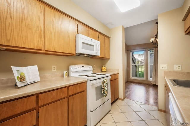 3330 Templeton Gap Rd Unit 15, Colorado Springs, CO 80907 - kitchen with white appliances, light countertops, light tile patterned floors, and a sink