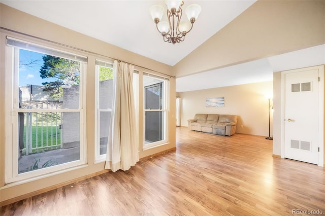 3330 Templeton Gap Rd Unit 15, Colorado Springs, CO 80907 - interior space with light wood-style floors, a chandelier, vaulted ceiling, and baseboards