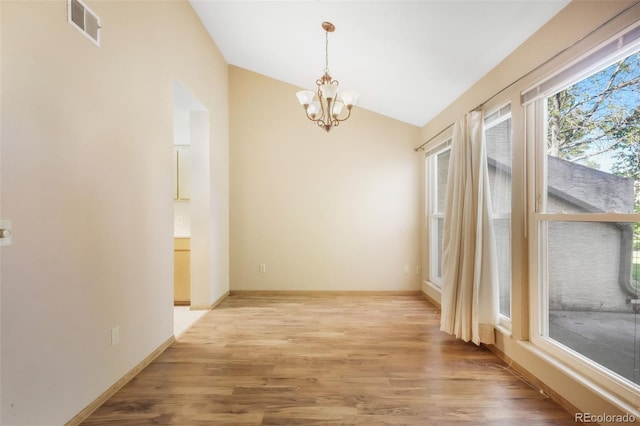 3330 Templeton Gap Rd Unit 15, Colorado Springs, CO 80907 - unfurnished room featuring lofted ceiling, a chandelier, light wood-type flooring, and baseboards