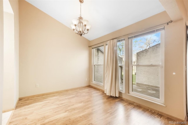3330 Templeton Gap Rd Unit 15, Colorado Springs, CO 80907 - spare room with vaulted ceiling, wood finished floors, and a chandelier