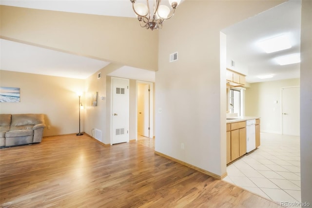 3330 Templeton Gap Rd Unit 15, Colorado Springs, CO 80907 - unfurnished living room featuring a chandelier, light wood-type flooring, and baseboards