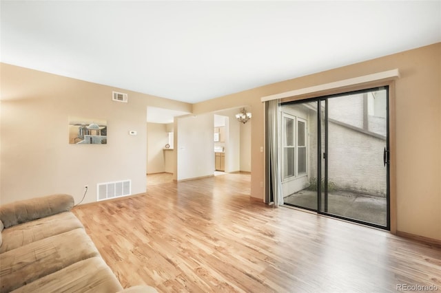 3330 Templeton Gap Rd Unit 15, Colorado Springs, CO 80907 - living area featuring a chandelier, wood finished floors, and baseboards