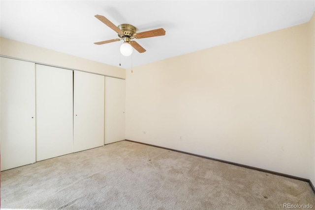 3330 Templeton Gap Rd Unit 15, Colorado Springs, CO 80907 - unfurnished bedroom with light colored carpet, a closet, baseboards, and a ceiling fan