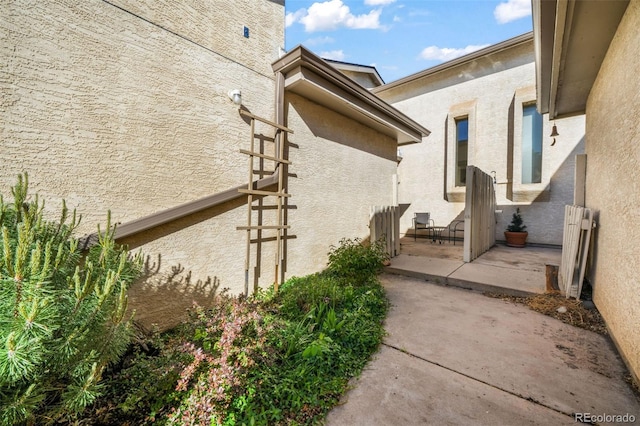 3330 Templeton Gap Rd Unit 15, Colorado Springs, CO 80907 - view of side of home featuring stucco siding and a patio
