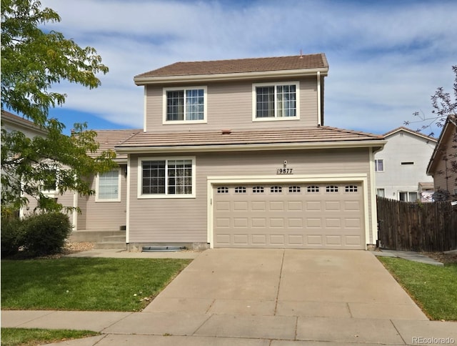 19877 E 40th Ave, Denver, CO 80249 - traditional home with a tile roof, an attached garage, concrete driveway, and fence
