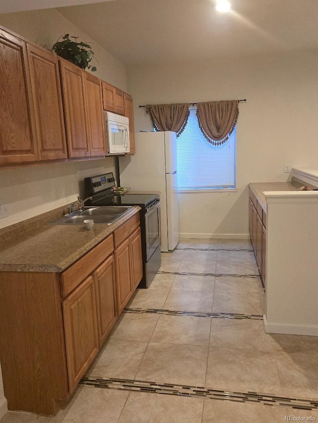 kitchen with stainless steel electric range oven and sink