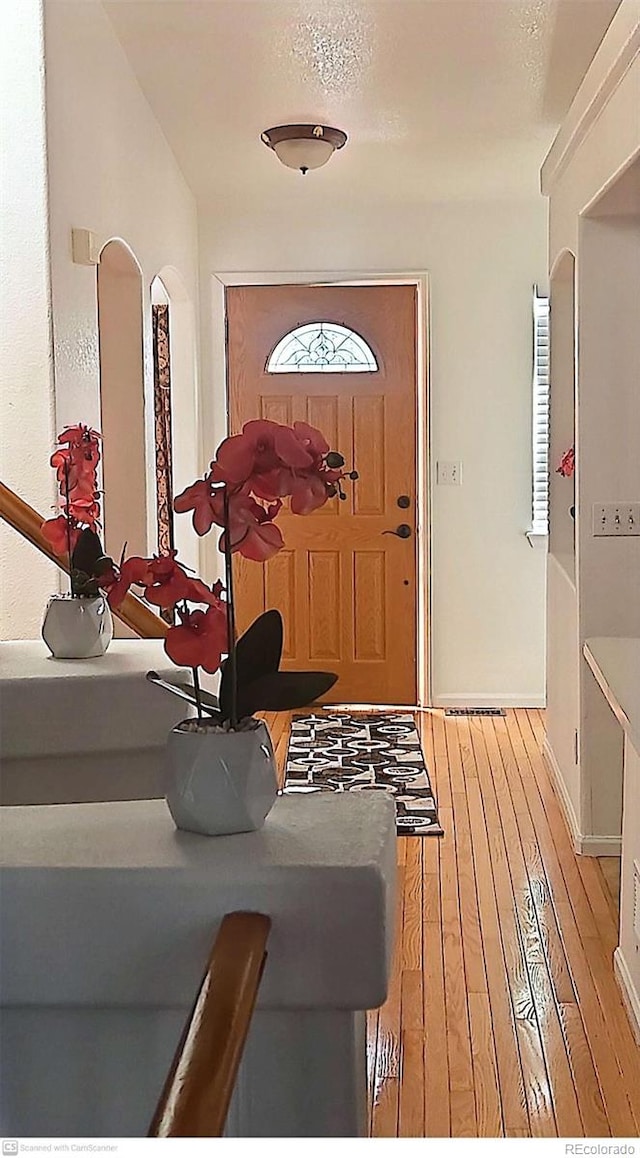 entrance foyer with a textured ceiling and hardwood / wood-style flooring