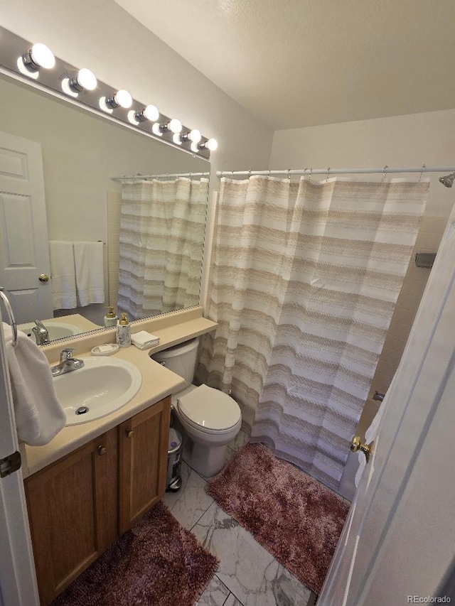 bathroom with vanity, a shower with shower curtain, and toilet