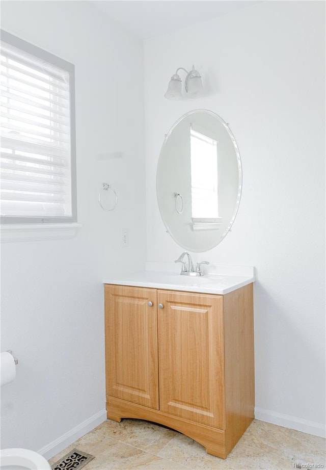 bathroom with tile patterned floors, a wealth of natural light, and vanity