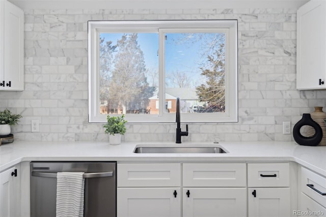 kitchen with sink, white cabinetry, stainless steel dishwasher, and plenty of natural light