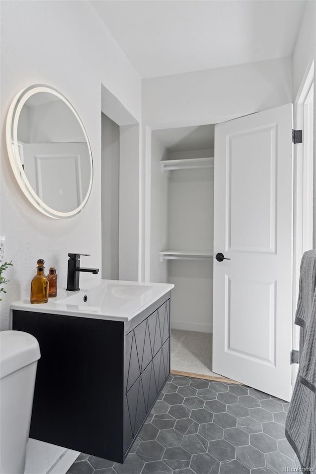 bathroom with toilet and vanity