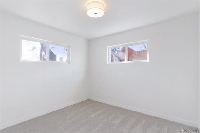 unfurnished room with light colored carpet