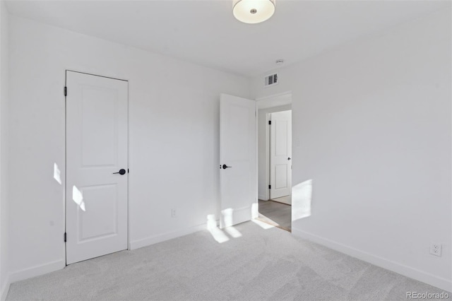 unfurnished bedroom featuring light colored carpet