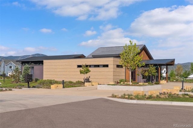 11103 Cloud Shadow St, Littleton, CO 80125 - view of front facade featuring a mountain view, curved driveway, and a standing seam roof