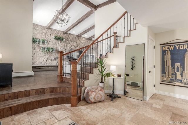 stairway featuring baseboards, beamed ceiling, stone tile floors, an inviting chandelier, and a baseboard radiator