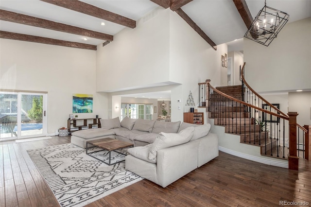 living room featuring a chandelier, stairs, baseboards, and wood-type flooring