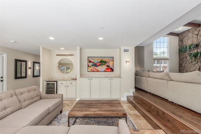 living room featuring recessed lighting, visible vents, wine cooler, and a bar