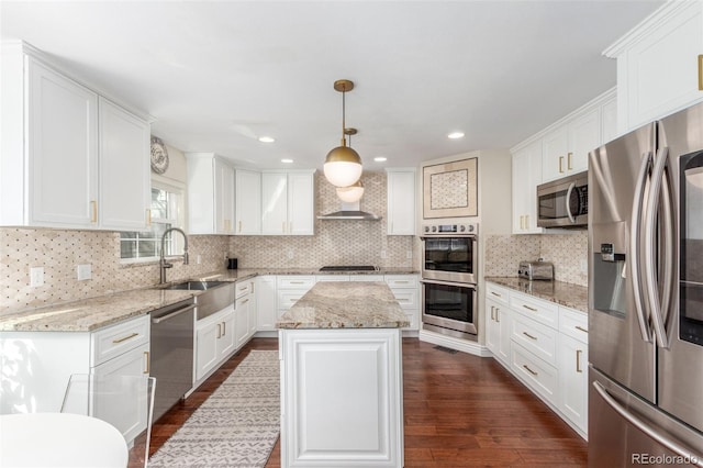 kitchen with white cabinets, appliances with stainless steel finishes, and a sink