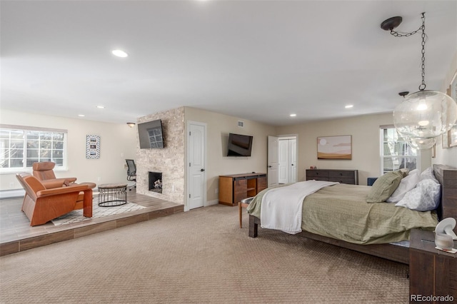 bedroom with recessed lighting, carpet, a fireplace, a baseboard radiator, and baseboards