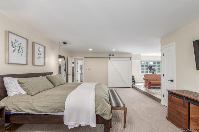 bedroom featuring recessed lighting, a barn door, visible vents, and carpet flooring