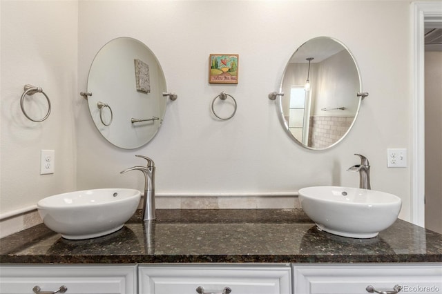 full bath featuring double vanity and a sink