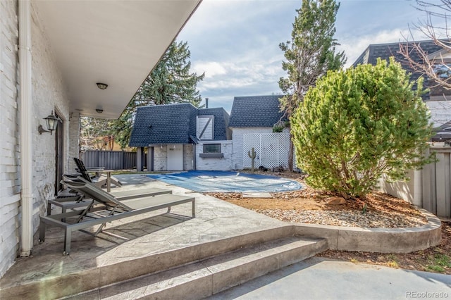 view of patio with an outbuilding and a fenced backyard