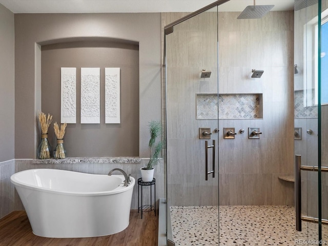 10531 Lieter Pl, Lone Tree, CO 80124 - full bathroom featuring a soaking tub, a shower stall, wood finished floors, and tile walls