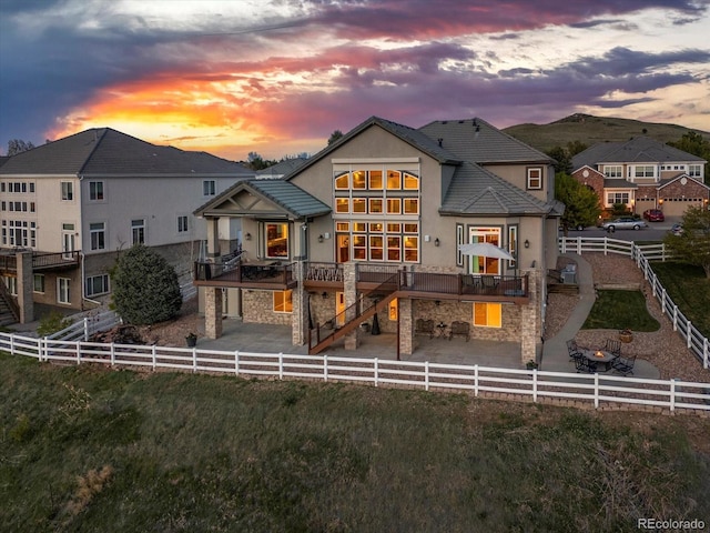 10531 Lieter Pl, Lone Tree, CO 80124 - back of property with stone siding, stucco siding, stairs, and a fenced backyard