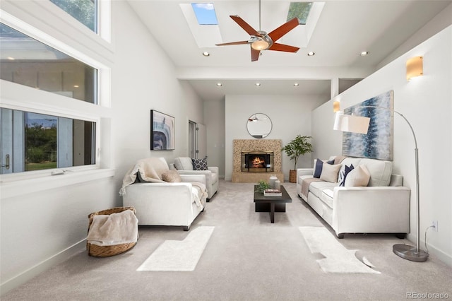 4398 Carter Trl, Boulder, CO 80301 - carpeted living room featuring a skylight, a warm lit fireplace, high vaulted ceiling, recessed lighting, and ceiling fan