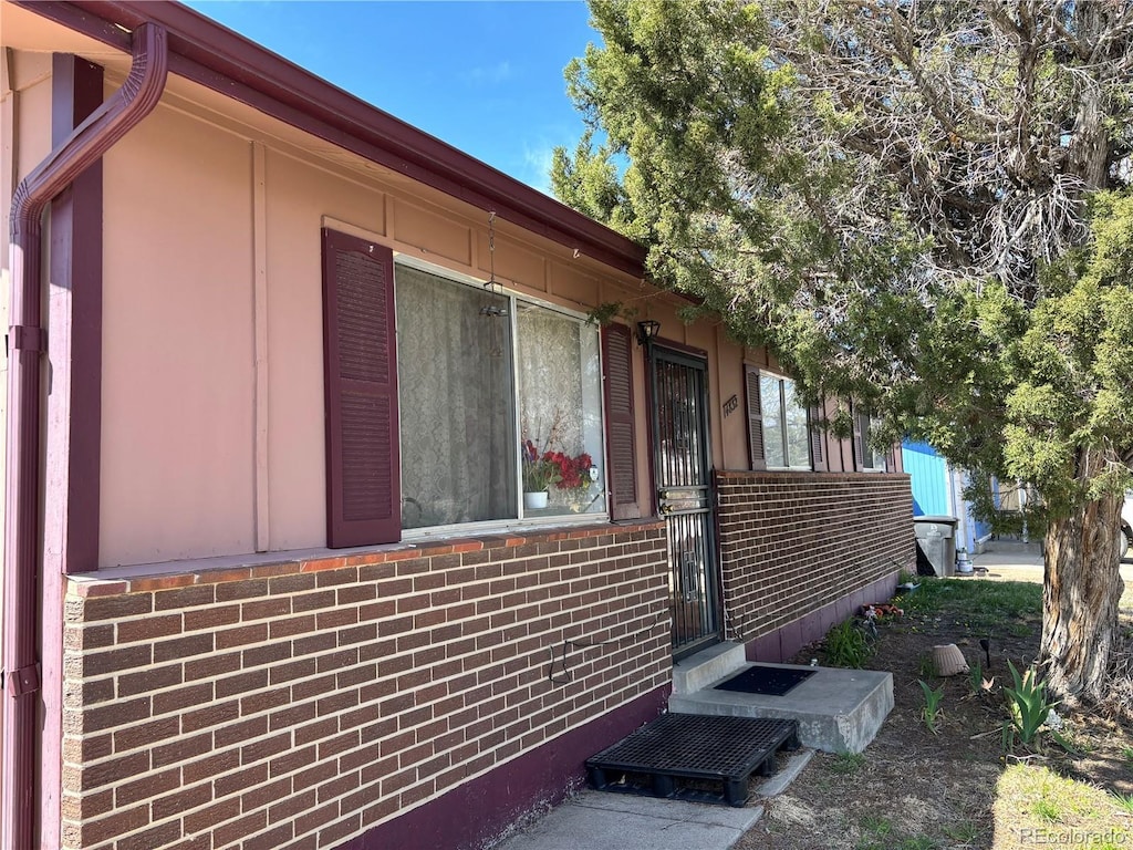 view of property exterior with brick siding