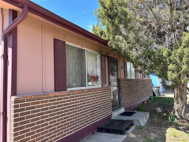 view of property exterior with brick siding