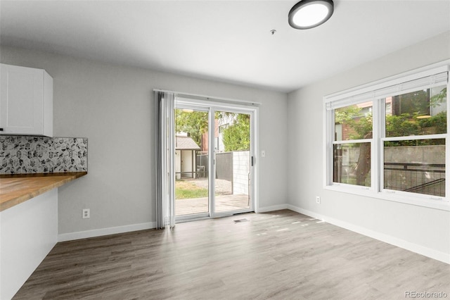 interior space featuring baseboards and wood finished floors