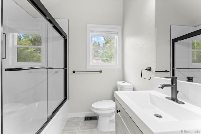 full bath featuring enclosed tub / shower combo, toilet, vanity, visible vents, and baseboards