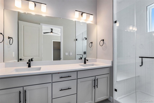 bathroom with walk in shower, vanity, and ceiling fan