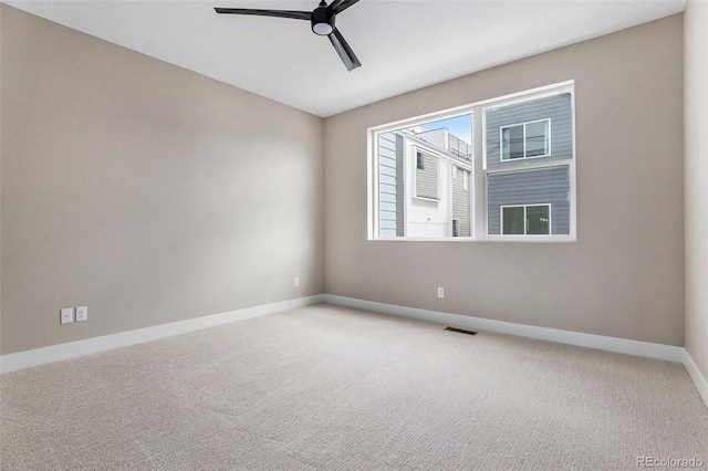 spare room featuring carpet flooring and ceiling fan