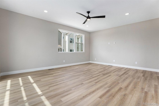 spare room featuring ceiling fan and light hardwood / wood-style flooring