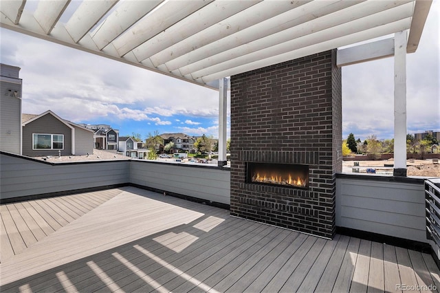 deck with an outdoor brick fireplace