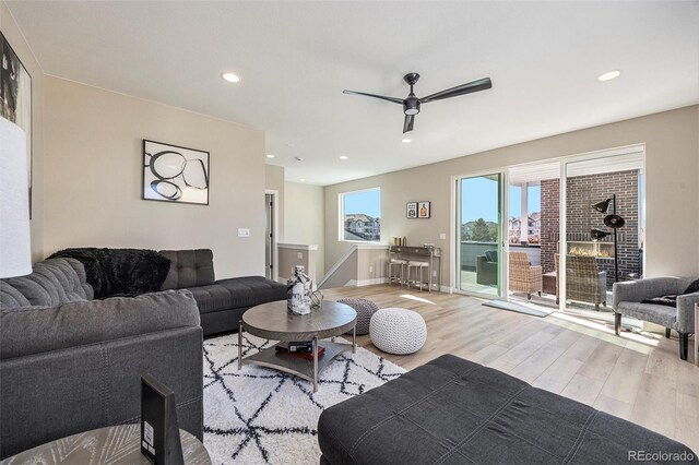 living room featuring recessed lighting, baseboards, ceiling fan, and wood finished floors