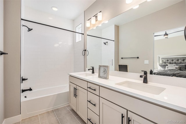 full bathroom featuring double vanity,  shower combination, ensuite bathroom, and a sink