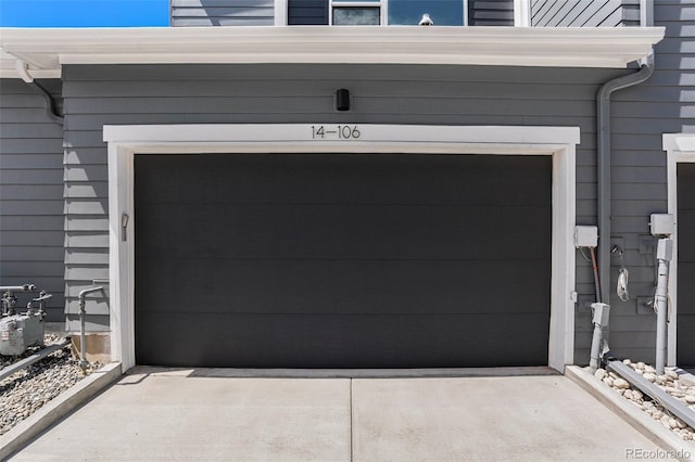 garage featuring concrete driveway