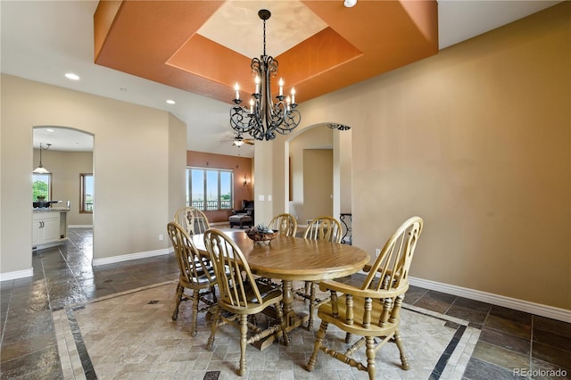 31200 E 145th Ave, Brighton, CO 80603 - dining space featuring arched walkways, stone tile flooring, plenty of natural light, recessed lighting, and a raised ceiling
