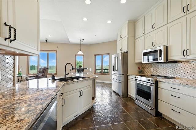 31200 E 145th Ave, Brighton, CO 80603 - kitchen with stainless steel appliances, plenty of natural light, recessed lighting, tasteful backsplash, and light stone counters
