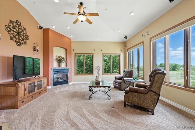 31200 E 145th Ave, Brighton, CO 80603 - carpeted living area featuring plenty of natural light, lofted ceiling, a glass covered fireplace, a ceiling fan, and recessed lighting